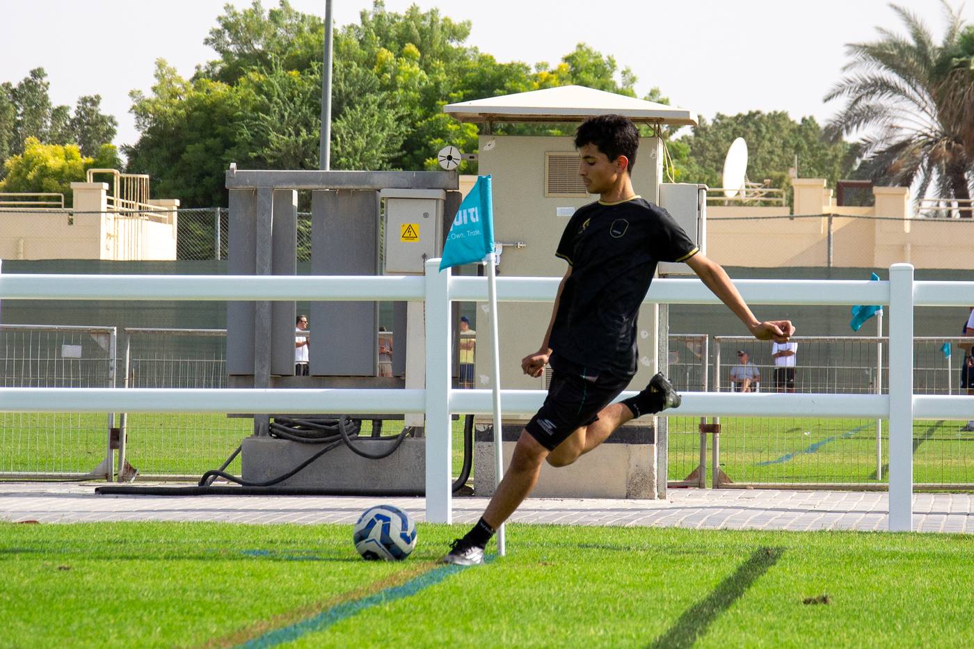 Origin FC youth footballer striking ball during match